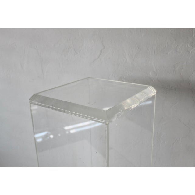 1980s clear Lucite acrylic pedestal stand, often used for displaying art or sculptures. Fabulous low-profile stand to...