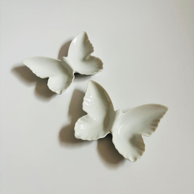 A vintage divided ceramic tray in the shape of a butterfly. Finished in a glossy white glaze. Perfect for using as a...