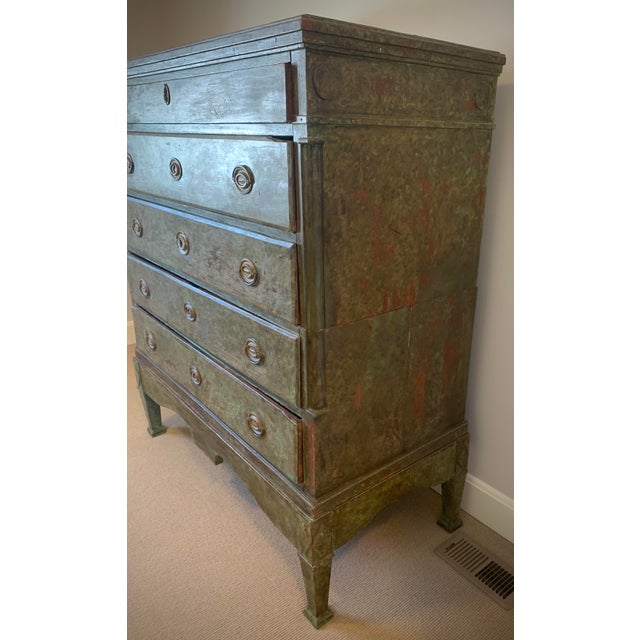 A stunning early 20th century rustic European high chest, beautifully crafted in solid wood and finished in an exceptional...