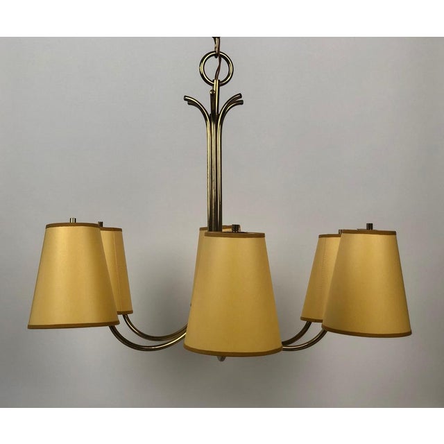 Large chandelier in brass with six arms, designed by Josef Frank in the 1950's, Austria. The silk shades in a yellow...