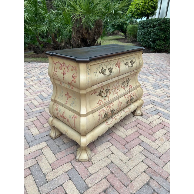 A beautiful vintage French bombé chest of drawers, showcasing the graceful serpentine silhouette and refined detailing...
