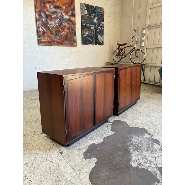 Pair of mid century modern Brazilian rosewood filing cabinets, featuring built-in shelving, two small drawers in each and...