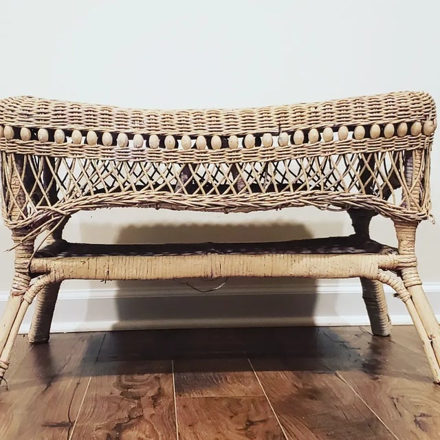 This very vintage wicker coffee table is so charming. It has 2 tiers and between them are all original intricate wood...