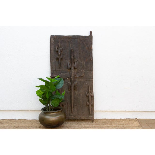 Attributed to the late 19th to early 20th century (circa 1890s–1920s), this authentic 71-inch architectural door is a...