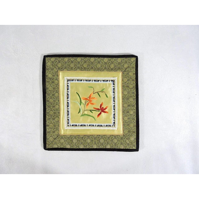 Pair of pretty 1980's embroidered Chinese table or lamp mats. Each mat has a red and orange flowers embroidered on to the...