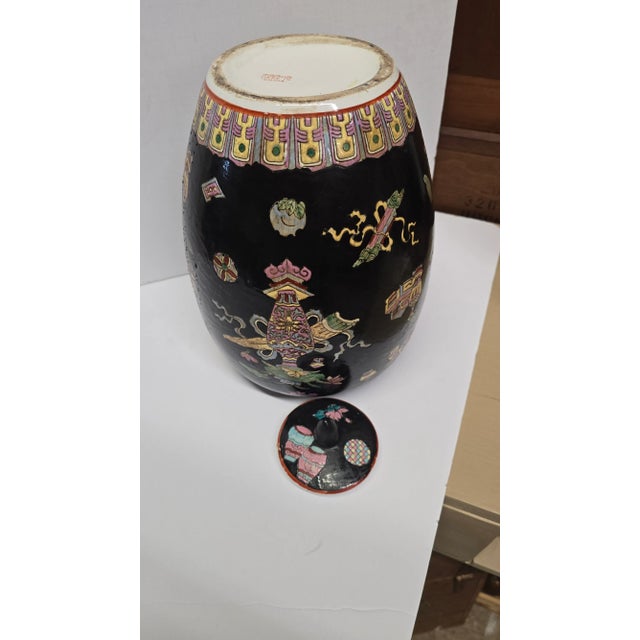 A ceramic Ginger Jar with black background. Beautiful vibrant colored designs. So many saturated colors like periwinkle,...