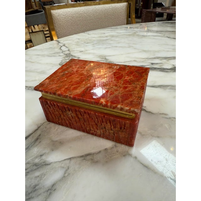 Rectangular vintage jewelry or trinket box crafted from richly colored red onyx stone, known for its deep crimson tones,...
