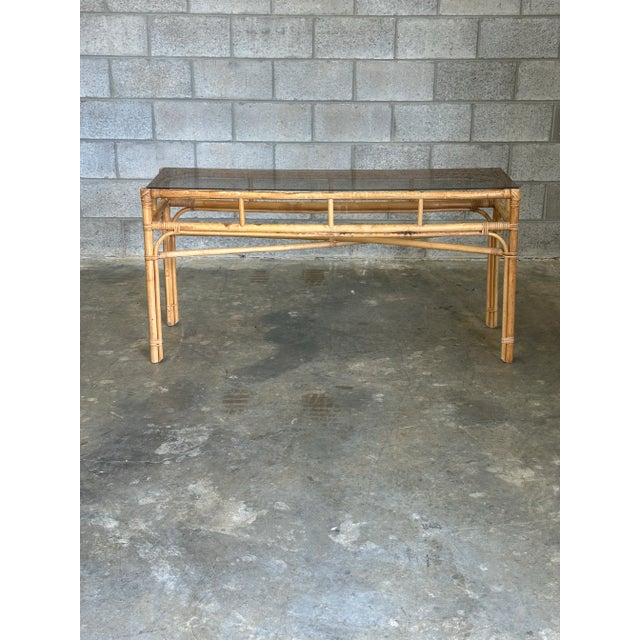 Wonderful vintage bamboo console table in a coastal or boho chic style. Bamboo frame with cane wrapped joints, completed...