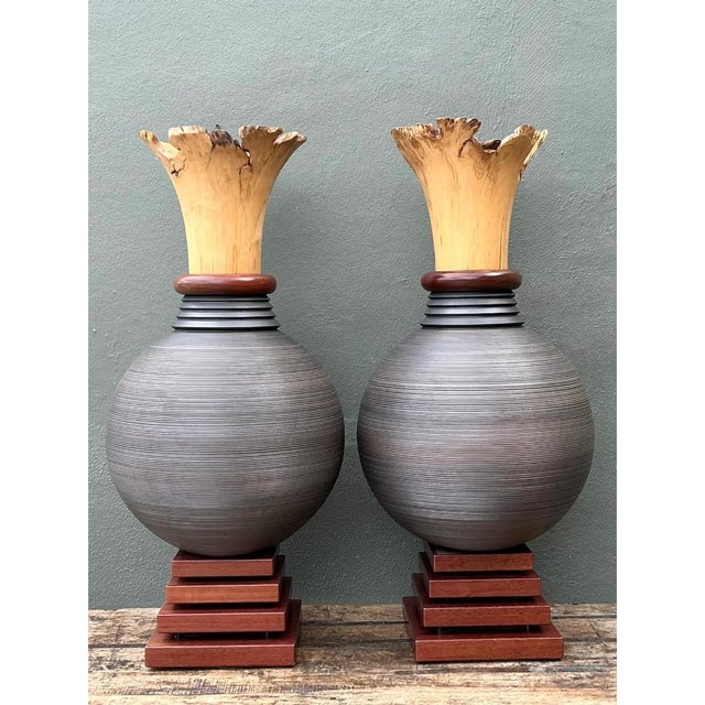 This monumental pair of sculptural wood urns marries raw organic energy with precise, lathe-turned artistry. Each vessel...