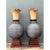 This monumental pair of sculptural wood urns marries raw organic energy with precise, lathe-turned artistry. Each vessel...