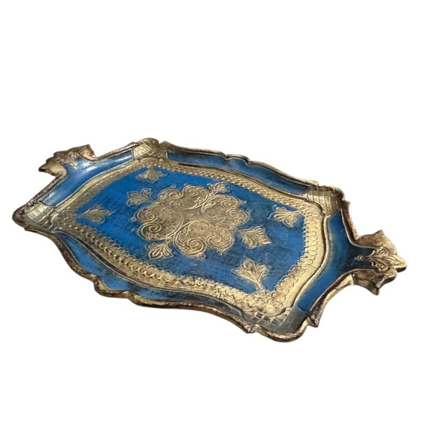 A beautiful hand painted Florentine tray in striking shades of blue and gold. This elegant piece reflects the classic...