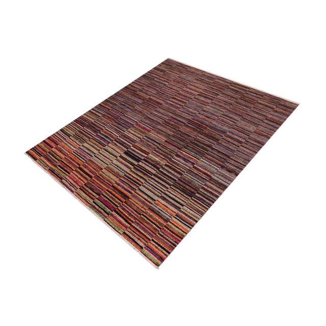 Elevate your interior with this hand-knotted high-low wool area rug, designed to bring depth and dimension to any room....