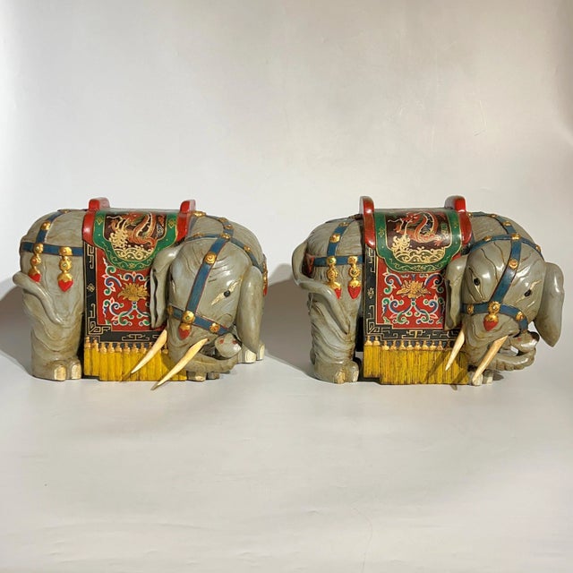 Pair of whimsical vintage wooden Chinese ceremonial processional elephants with hand-painted Chinese designs.