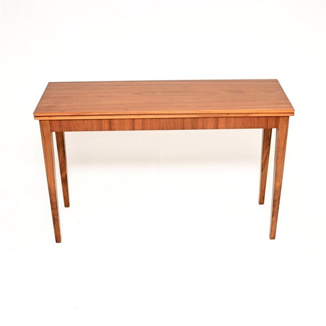 A stylish and extremely well made vintage Swedish walnut metamorphic console / dining table. This was made in Sweden in...