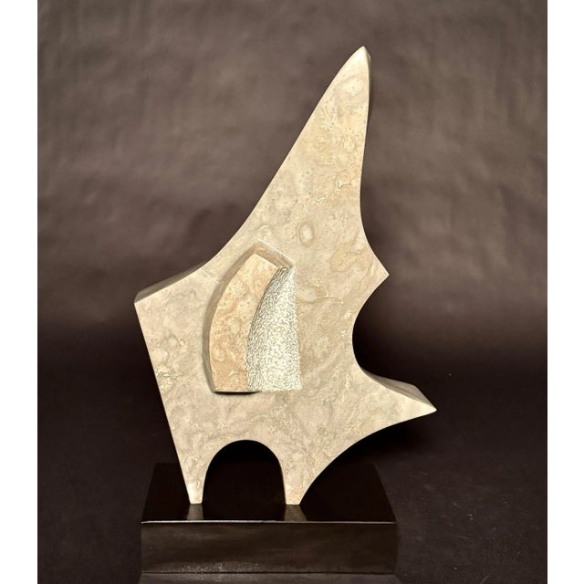 Beautiful geometric form carved marble abstract form sculpture. A gray and white marble, with a faint green hue is...