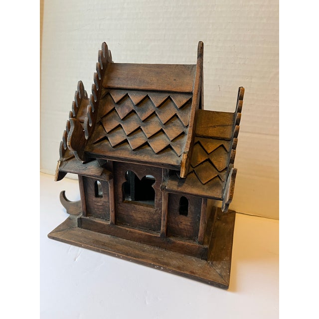 A single antique teak wood Thai spirit house model.