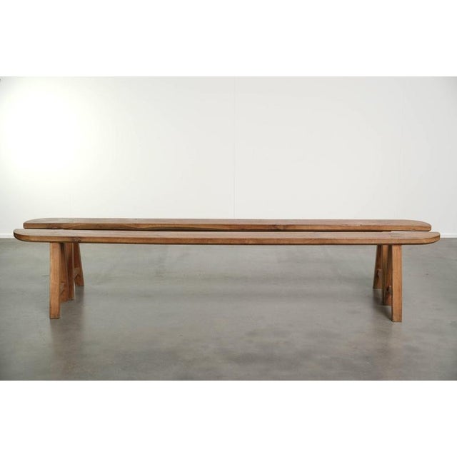 This lovely set of 2 antique French wooden benches/farmhouse benches features a beautiful warm light color scheme and a...