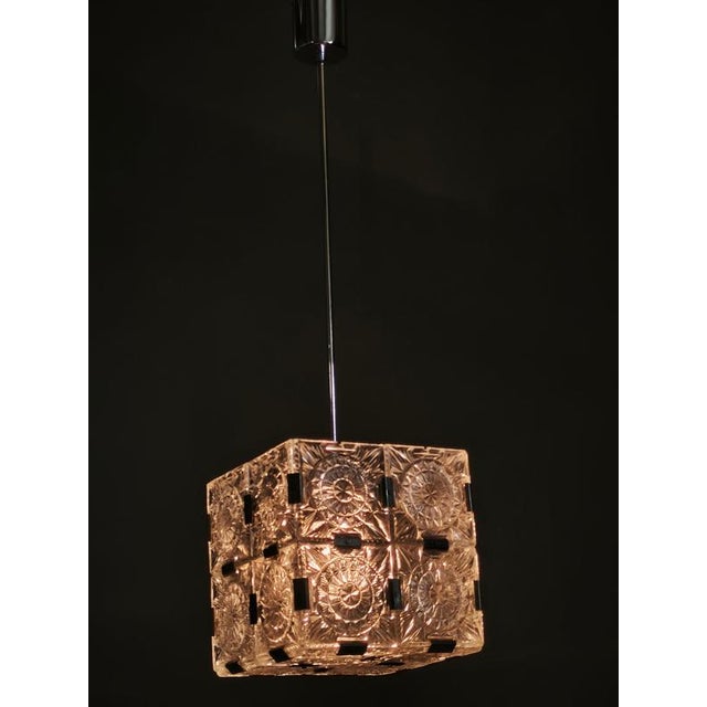 Exceptional geometric pendant light produced in kamenický šenov, czechoslovakia, during the 1970s. The chandelier is...