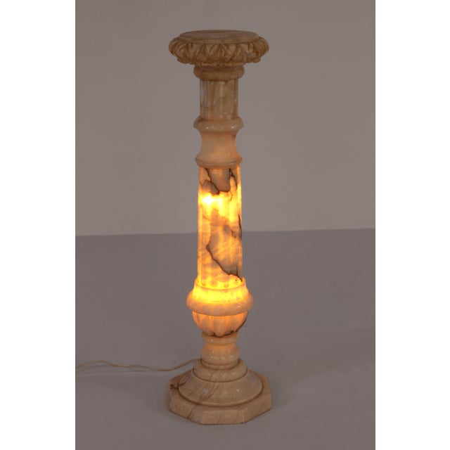 Elegant marble pedestal with integrated led lighting, perfect for showcasing art, vases, or floral arrangements. A...