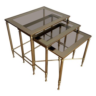 1940s Neoclassical style brass nesting tables. French work by Maison Jansen. For Sale