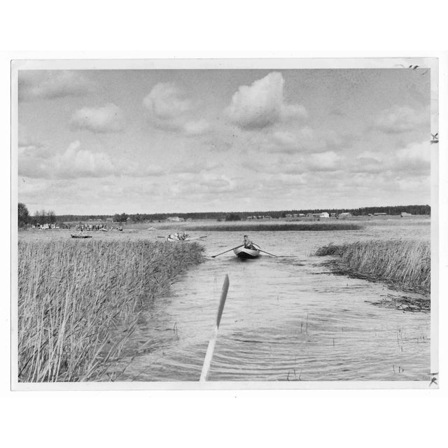 1960 photo of people in Finland rowing to church. Publication information on the back.