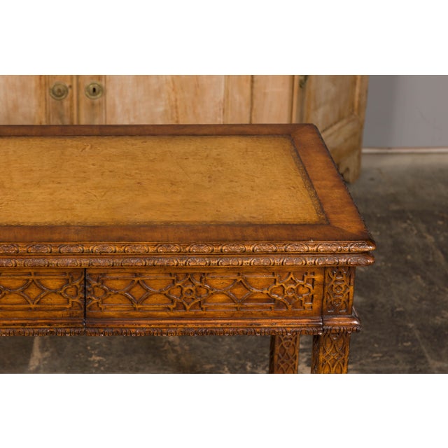 An English Midcentury game table with leather unfolding top and abundantly carved décor. This English Midcentury game...