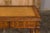 An English Midcentury game table with leather unfolding top and abundantly carved décor. This English Midcentury game...