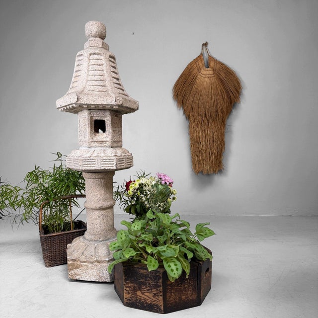 A slender Japanese garden lantern with an elegant roof and a softly weathered appearance. Dimensions: height 120 cm,...
