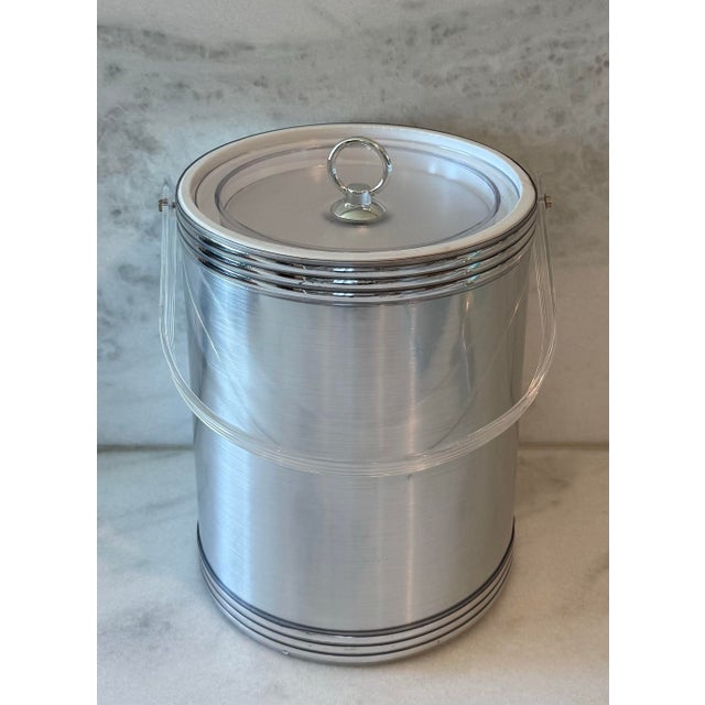 Vintage 1980s tall ice bucket with a silver foil finish and lucite handle and lid. Made in the USA. 10" high to the top of...