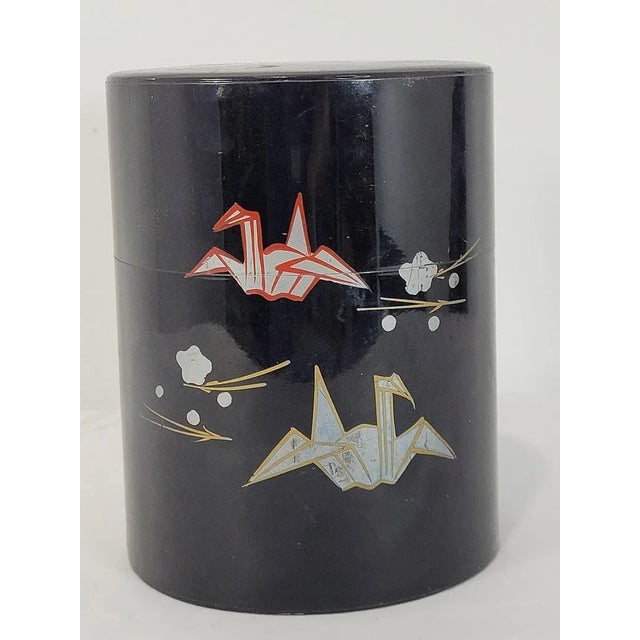 Vintage Japanese black lacquer lacquerware style tin box / tea canister with a pattern of Origami birds. Exact age is...