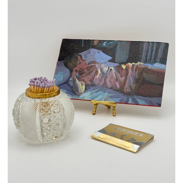 A cut-glass match holder with a brass collar, from the era when a house had a dedicated object for every small ritual and...