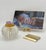 A cut-glass match holder with a brass collar, from the era when a house had a dedicated object for every small ritual and...