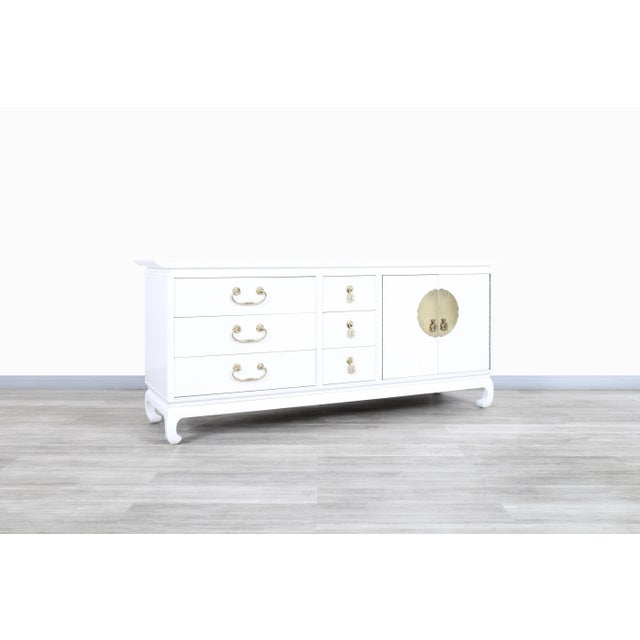 Amazing vintage Hollywood Regency lacquered and brass credenza designed and manufactured in the United States, circa...