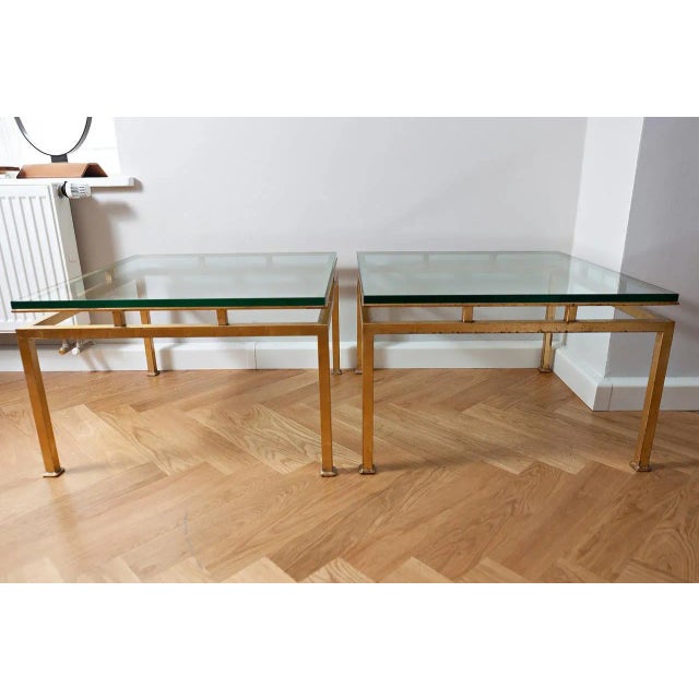 Pair of side table, France, circa 1960, rectangular brass, gilded and thick clear glass. Measures: Height 43.5 cm, 70 cm x...