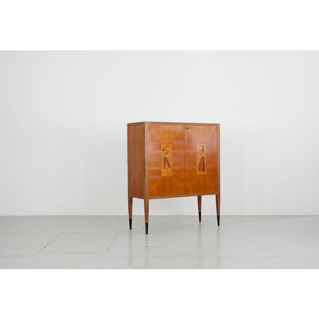 Bar cabinet from Italy, 1950s. Walnut veneer with two inlays of different woods with traditional figures, inside mirror...