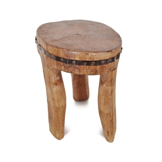 Original old Nagaland wood stool. Carved from a single piece of indigenous hardwood each with unique decorative iron trim...