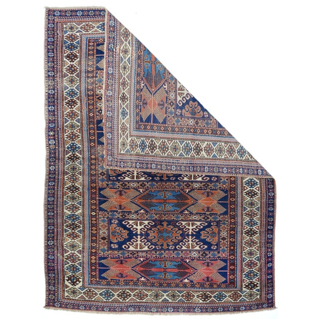 This very rare, probably east Caucasian/west Caspian, scatter in an enlarged soumak bag face design shows seven panels...