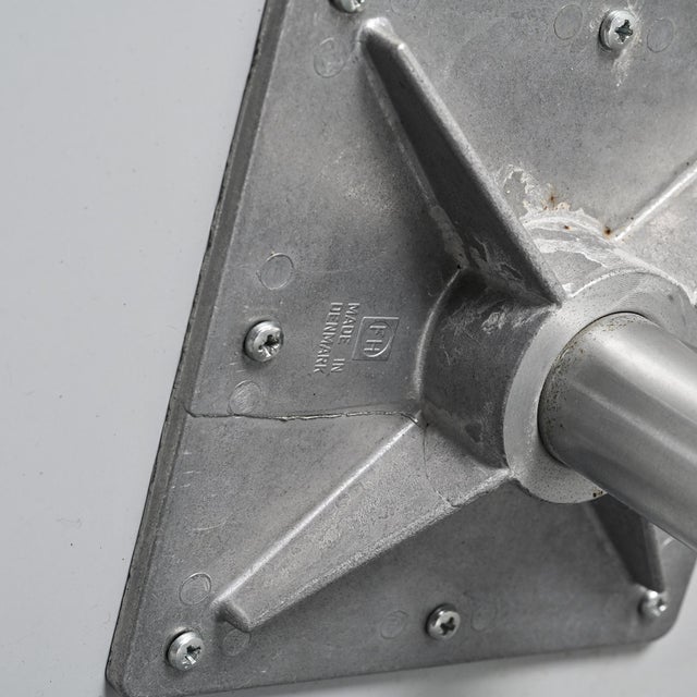 Circular coffee table designed by Arne Jacobsen and produced by Fritz Hansen, circa 1970. The round white laminate top has...