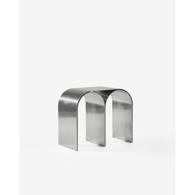 Silver arch stool in polished aluminium by pietro franceschini. Dimensions: w 54 x l 31.5 x h 43 cm. Materials: polished...