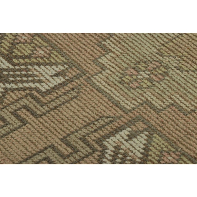 Made with hand-knotted wool, this 2x3 gift-sized vintage Turkish rug originating circa 1950-1960, is a bold new addition...