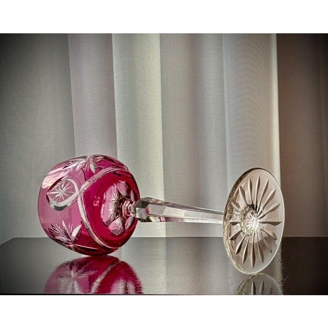 A set of six vintage hock wine glasses in ruby cut-to-clear crystal. the rounded bowls feature alternating radiating...