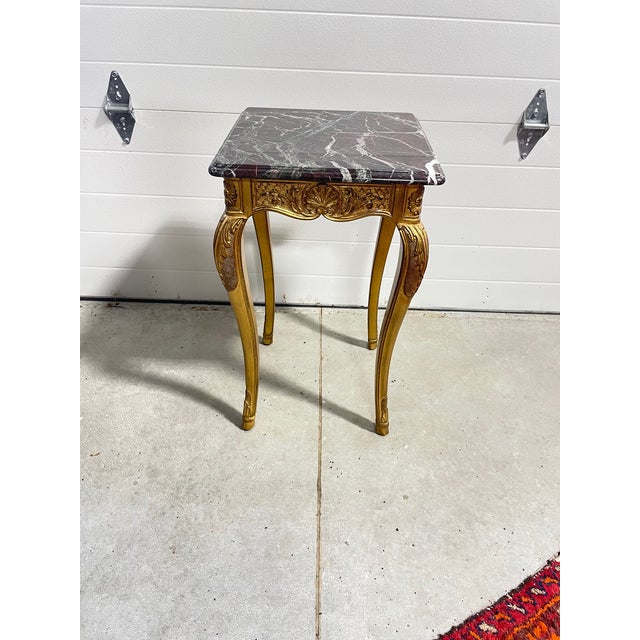 A lovely marble topped gold leaf finished accent side table, perfect as a drinks table, made by E.J. Victor as part of...