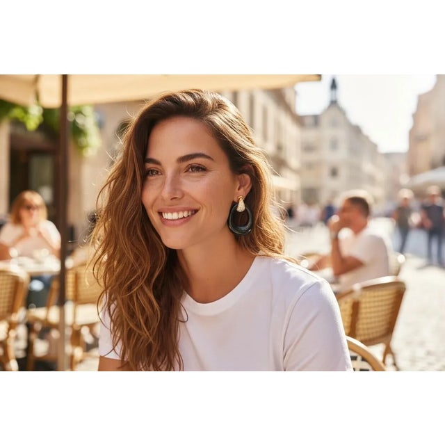 A bold statement of modern elegance, these 14K yellow gold earrings feature sleek carved onyx circles accented with...
