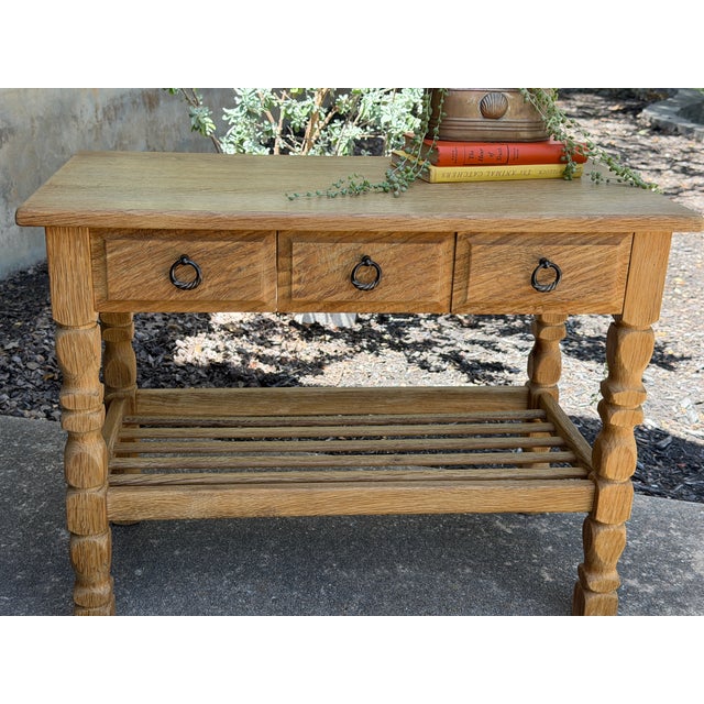 A beautiful and highly functional Danish oak table attributed to Henning Kjærnulf, featuring the designer’s signature...