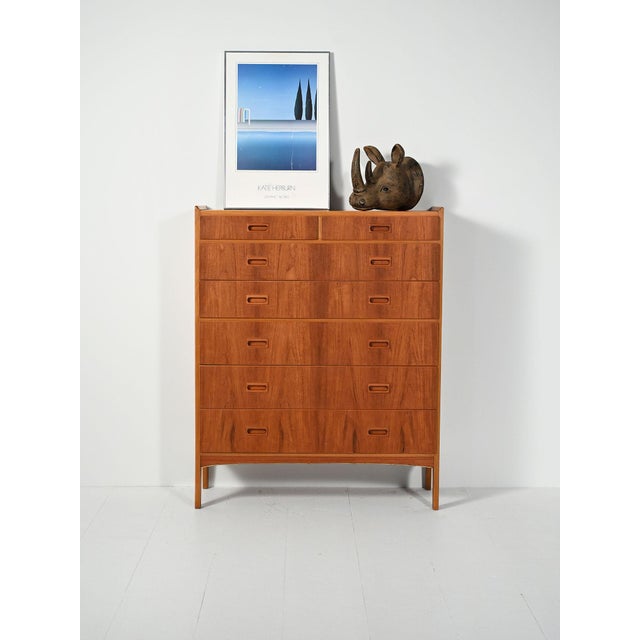 1960s seven-drawer chest with recessed handles and a protruding top profile. Made by Treman MöbelFabrik, with original...