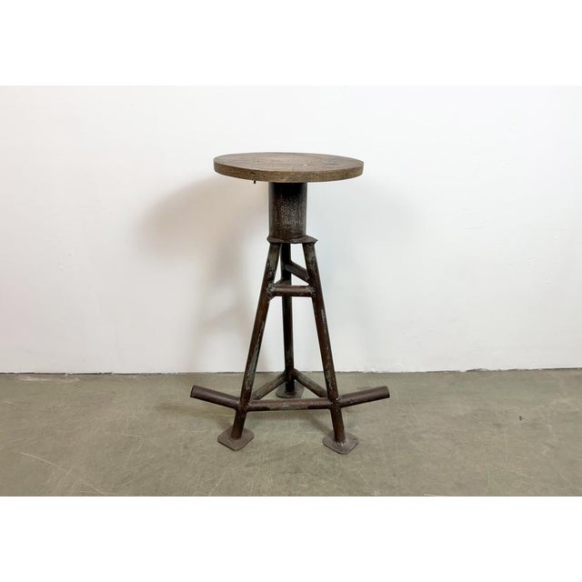 Vintage Industrial factory stool made in former Czechoslovakia during the 1960s It features a plywood seat and a brown...