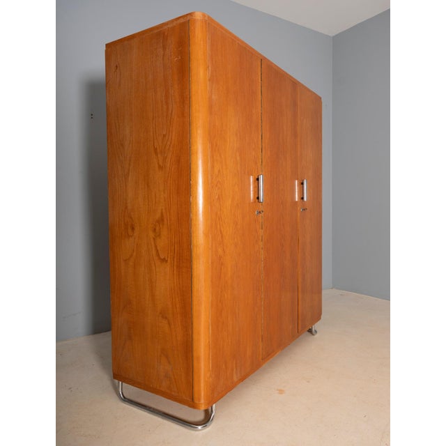 A large Bauhaus wardrobe with elegant chrome details, produced in former Czechoslovakia. Originally designed by Vichr &...