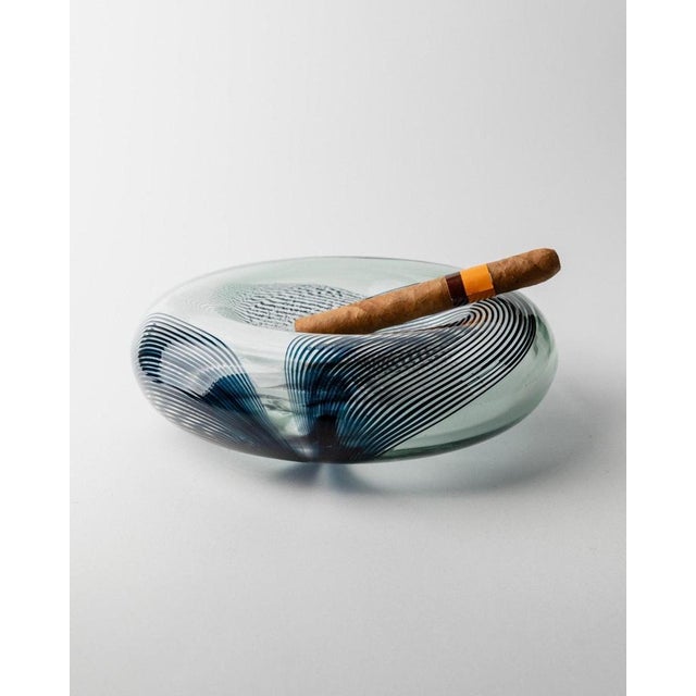 This vintage murano glass bowl, crafted with filigree glass and a twisted stripe pattern in a blueish hue, is a rare and...