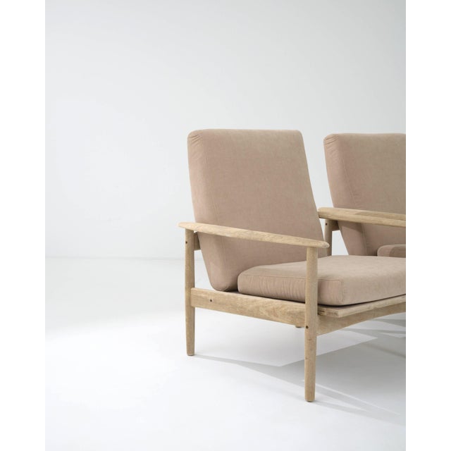 This attractive pair of vintage armchairs combine a stylish Modernist silhouette with a soothing color palette. Made in...