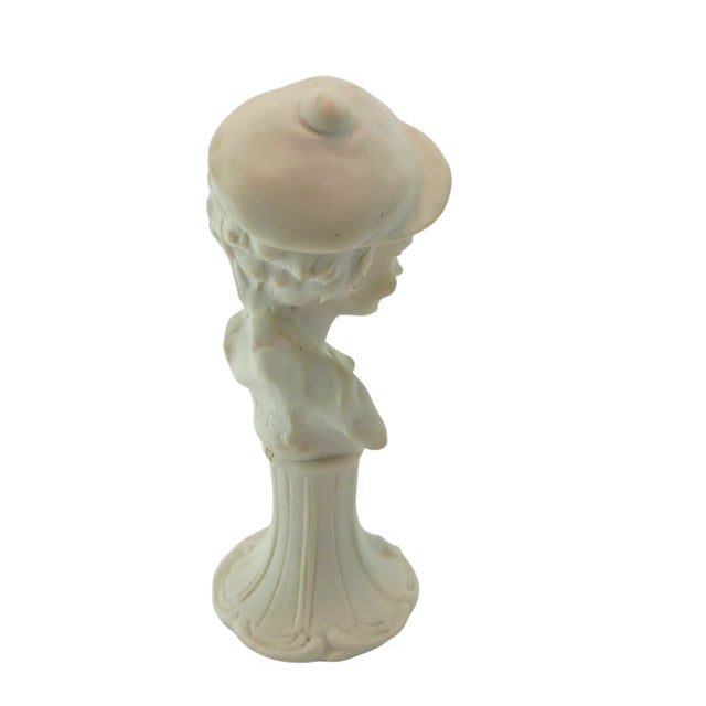 Beautiful 6" figurine made of porcelain. Image of a young boy during the 1920s-40s with a beautiful facial expression...